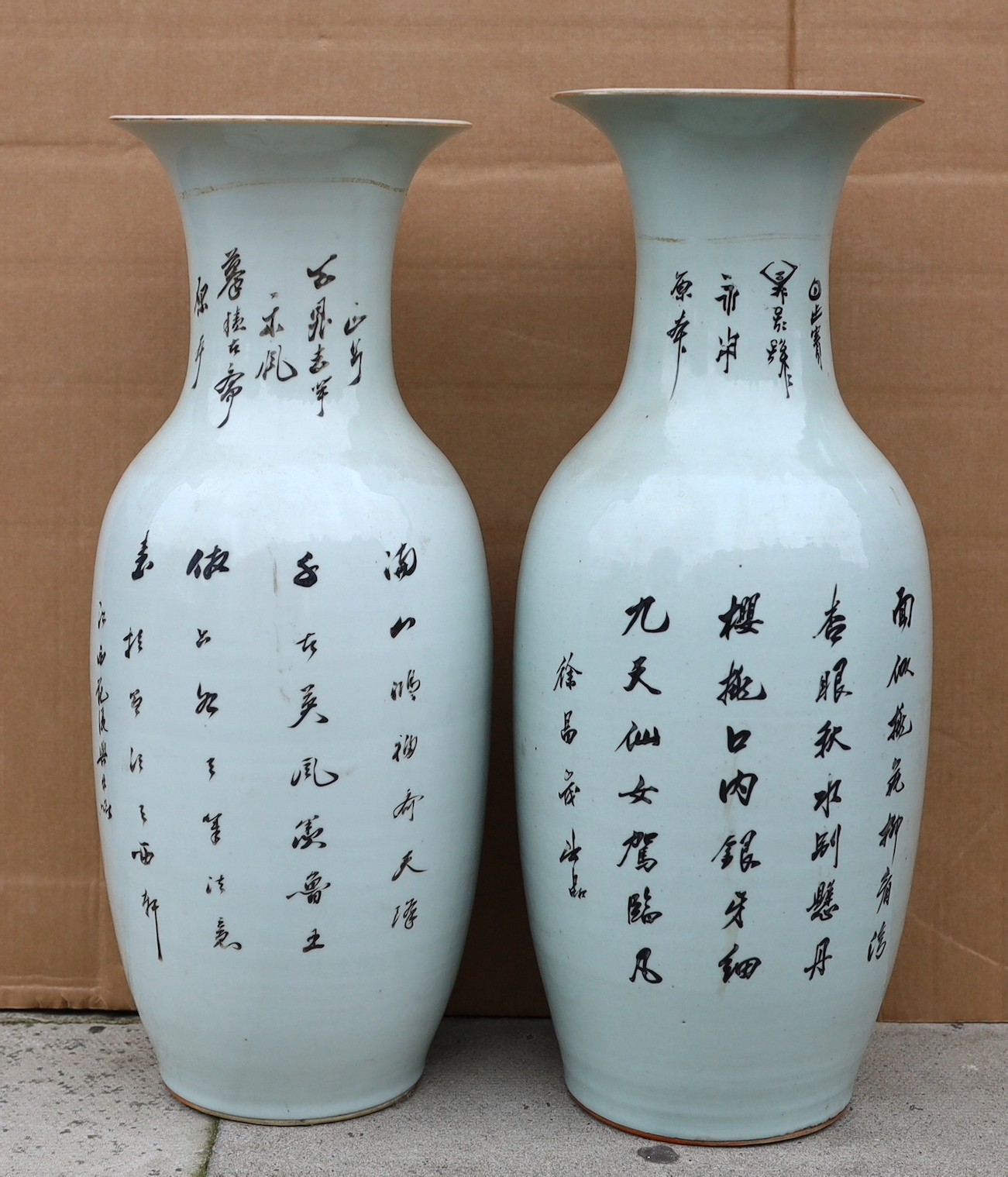 A pair of Japanese polychrome decorated porcelain baluster vases decorated with figures in gardens, height 57cm